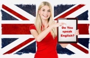 young woman holding tablet pc on the background with british national flag. english learning concept
